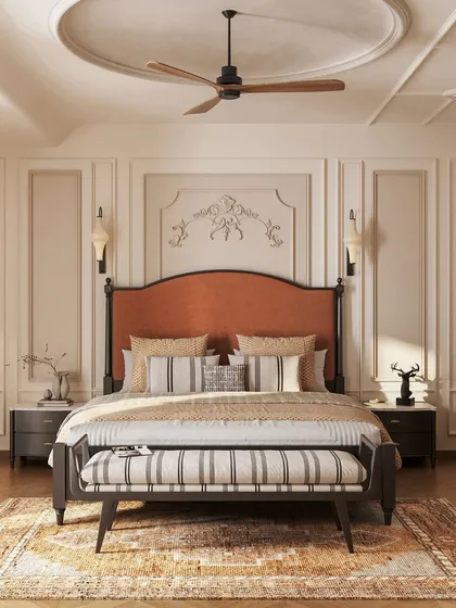 This master bedroom is a study in neoclassical elegance. We used classic wall moldings, a timeless two-poster bed with a rich rust-orange headboard, and a balanced, neutral palette to create a sanctuary that feels both grand and deeply restful.
