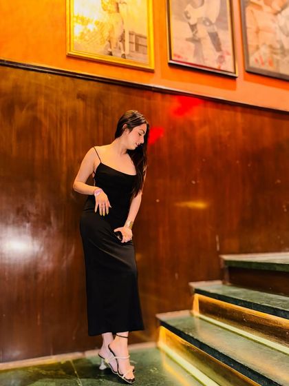 Another angle of the black slip dress, showcasing its simplicity and elegance.