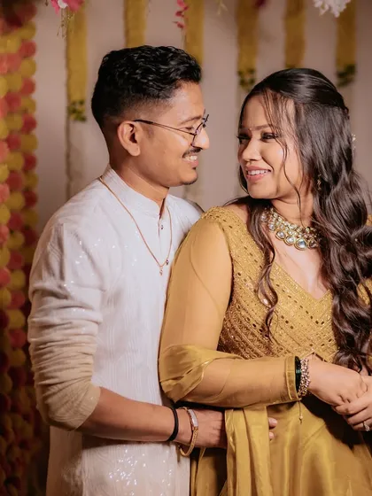 A happy Haldi ceremony. The makeup is minimal and radiant, letting the bride's natural glow and happiness shine through.