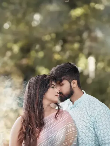 A dreamy and romantic portrait using a smoke bomb to create a soft, ethereal haze around the couple. The smoke adds a touch of magic and beautiful texture to the image.