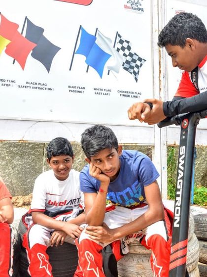 A group of our junior drivers in a debrief session. We foster a collaborative environment where drivers learn from our coaches and each other.