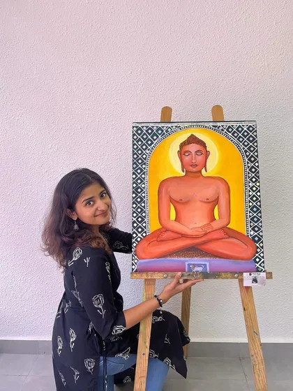 Another pose with the Mahavir Swami canvas. The vibrant colors and serene expression were central to capturing the essence of this spiritual figure.