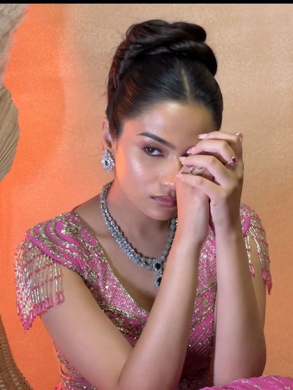 A stunning portrait of the model with her high fashion bun, showcasing a complete editorial look.