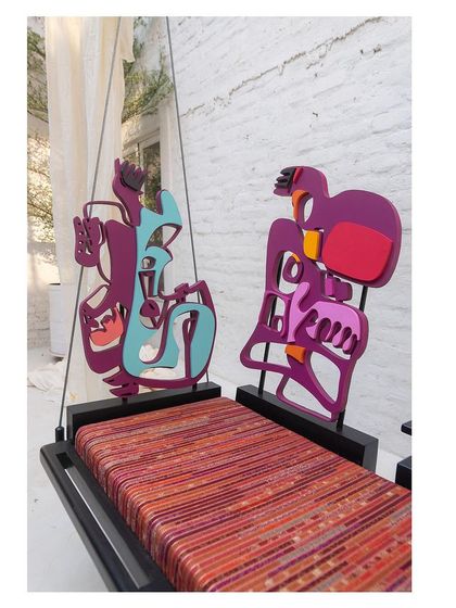 A close-up of the 'Kaleidochaos' swing with its colorful, abstract backrests in place, ready to spark conversation.