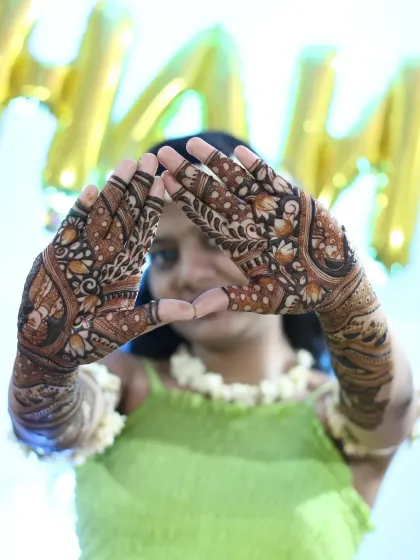 A creative pose showing off the intricate details of the bridal mehndi. I love when my clients have fun with their henna.