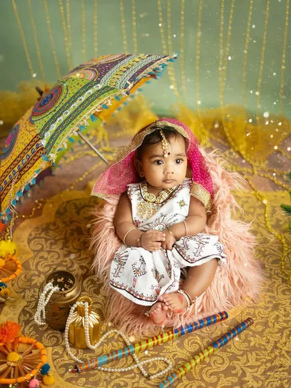A full view of the vibrant Navratri setup, with rich fabrics, festive props, and a beautifully dressed baby girl ready to celebrate.
