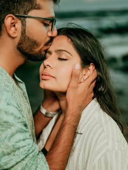 It's the small, tender moments that often tell the biggest story. This close-up from a Goa beach shoot focuses on a gentle forehead kiss, capturing the trust and affection between the couple. We believe in getting close to the heart of the story.