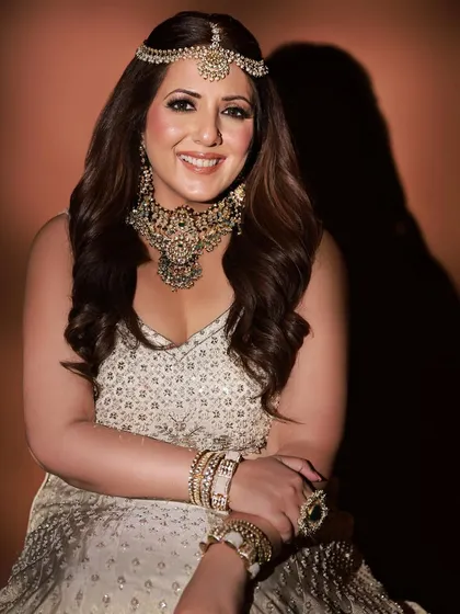 A happy and radiant close-up. This portrait showcases the heavy choker necklace and matching earrings, paired with soft, glamorous makeup and a beautiful smile.