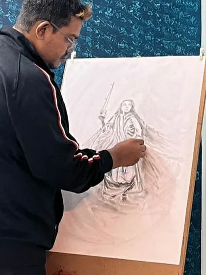 Here I am, working on a detailed graphite pencil drawing on an easel. In my classes, I guide students through the process of creating larger, more complex compositions.