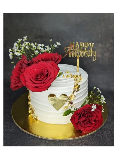 A beautiful anniversary cake with a fault-line heart design. This fresh pineapple cake is adorned with fresh red roses and baby's breath.