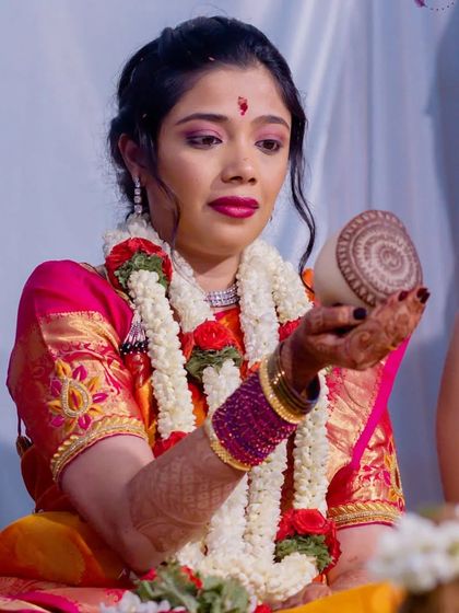 My client Vasuda during her Varapooja. Her dark, polished nails complemented her beautiful pink and orange saree and traditional jewelry.