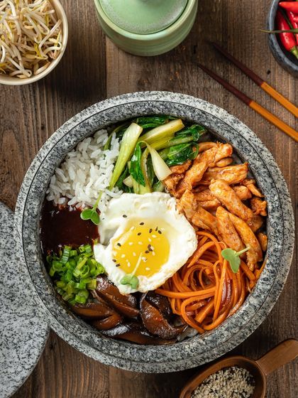 A chicken hot pot from YouMee, with a sunny-side-up egg and fresh vegetables.