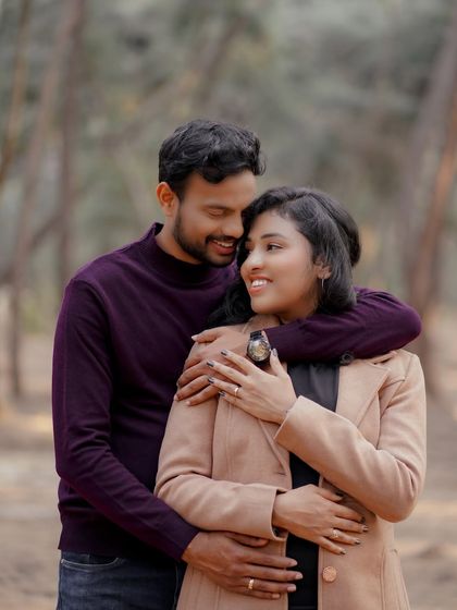 A close-up, intimate embrace from the same forest shoot. The soft, natural light and the couple's connection make this a warm and romantic portrait.