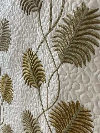 A close-up of the leaf appliqué and the surrounding quilting.