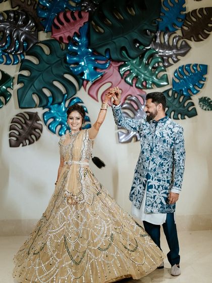 A classic twirl against a modern, tropical-themed backdrop. We ensure every photo opportunity is perfectly styled, blending the couple's outfits with our personalized decor.