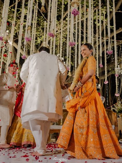 The bride looking back at her groom with a smile as they take their wedding vows.