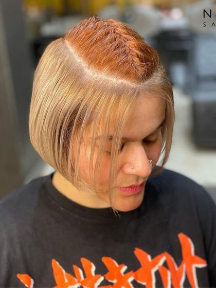 Another view of the peekaboo color, this time with a stylish braid on top to reveal the contrasting red shade. It's a playful and edgy look.