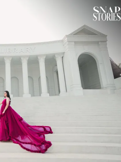 Using the grand steps of a library-style building to frame the bride's magnificent gown. This low-angle shot adds a sense of scale and drama to the pre-wedding portrait.