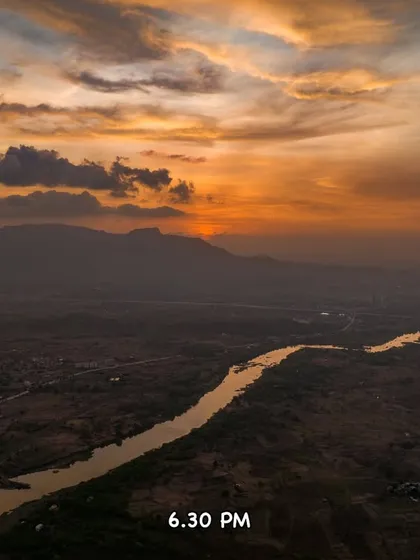 At 6:30 PM, the sun dips below the horizon, casting a golden glow over the river and the entire valley.