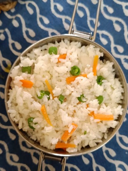 A close-up of my simple vegetable fried rice, with bits of carrot and peas. It's a light and tasty option that's part of my daily menu.