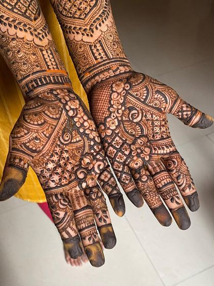 The palms of a full bridal mehendi, showcasing a dense and detailed design that is both traditional and timeless.