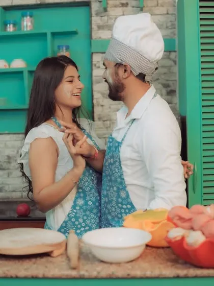 Love is cooking up something beautiful! This couple shares a laugh in a quirky kitchen setting, a perfect example of a themed pre-wedding shoot that reflects shared interests and creates fun, natural interactions.