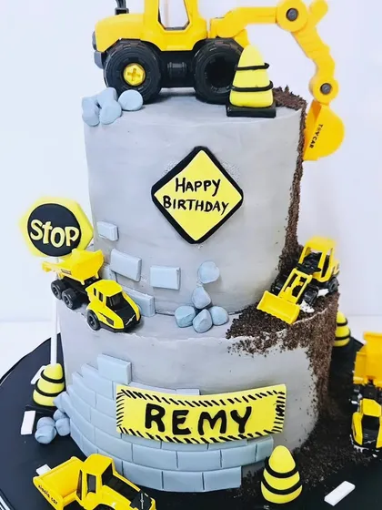 I love making kids' birthdays special, like with this detailed construction theme cake. It features edible trucks, traffic signs, and a fun 'under construction' site, all designed to delight the little one.