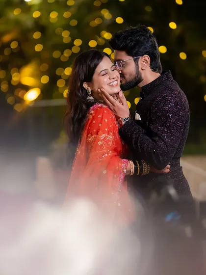 An intimate moment between Vivek and Shraddha during their evening portrait session. I love using ambient light, like these background bokeh lights, to create a dreamy, romantic atmosphere for candid couple photos.