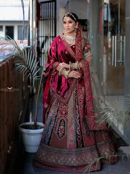 A poised, full-length portrait of the bride in her complete royal attire, showcasing the entire look from head to toe.