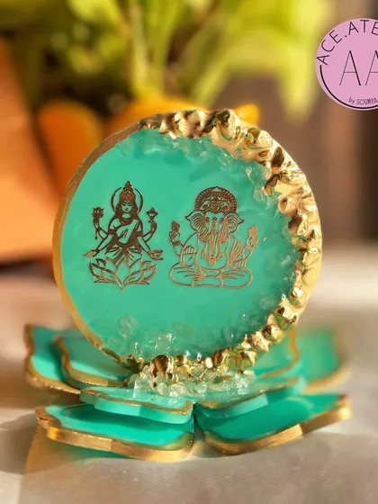The turquoise Lakshmi Ganesh standee, offering a unique and calming color palette. The combination of the serene blue-green with a golden lotus base is perfect for modern home decor.