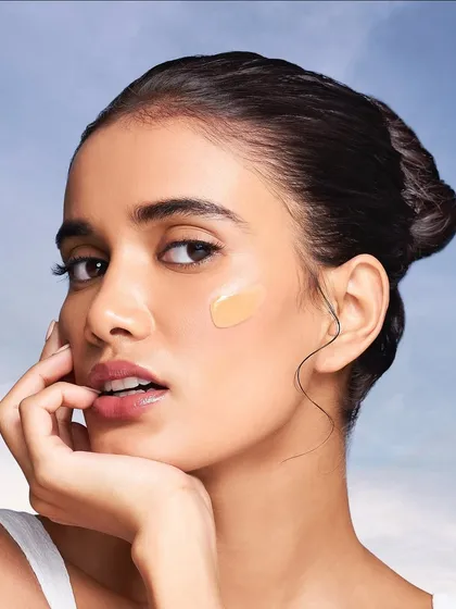 This shot highlights my philosophy of starting with a perfect canvas. It shows a swatch of foundation on fresh, dewy skin, emphasizing my commitment to creating a base that is radiant and looks like second skin, never heavy or cakey.