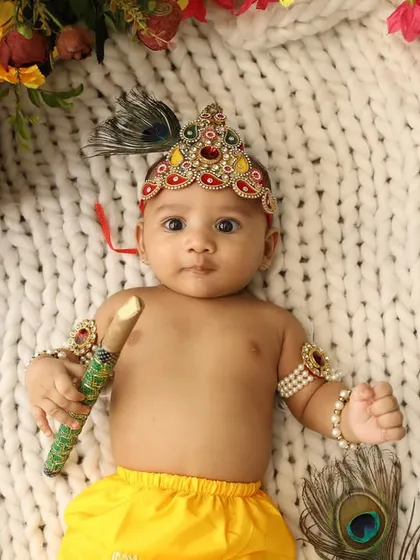 A close-up of our baby Krishna, holding his flute and looking at the camera. The details of his crown and jewelry are just beautiful.