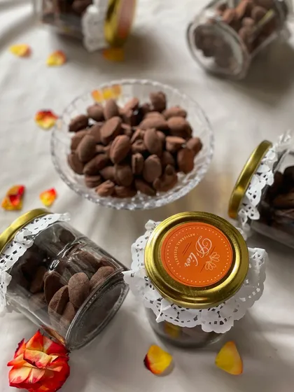 A beautiful spread of our choco almond jars, decorated with delicate lace doilies, perfect for elegant corporate or wedding gifting.
