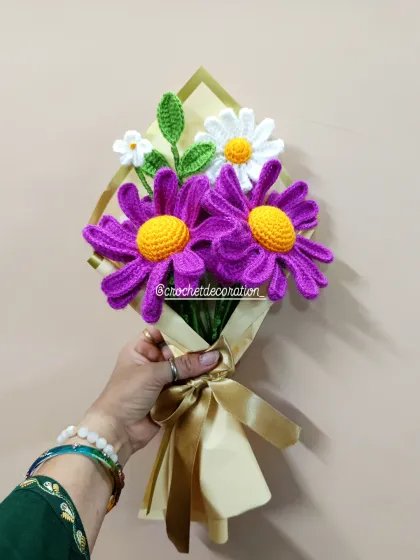 A vibrant bouquet featuring bold purple oxeye daisies and classic white daisies, beautifully wrapped and ready for gifting. Each petal is carefully stitched to create a realistic and lasting floral gift.