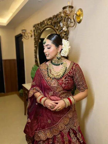 The side profile of this minimal bridal look, highlighting the clean hairstyle and flawless skin.