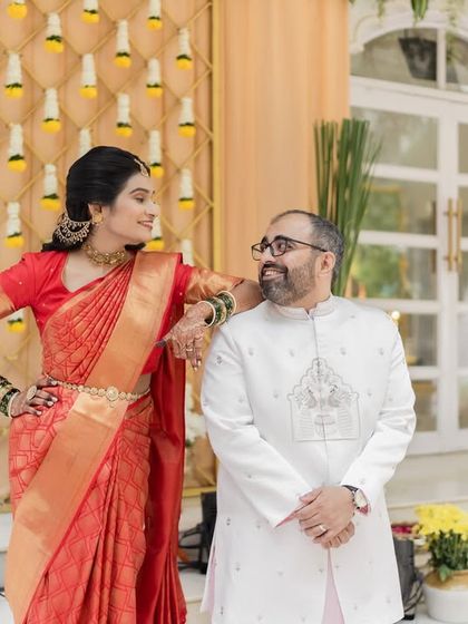 A playful and confident portrait of the couple. The bride's pose adds a touch of fun and personality to the shot.