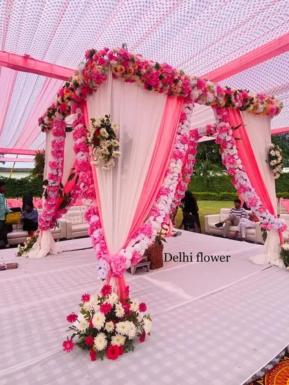 A side view of the pink and white mandap, showing the delicate floral ties and the elegant draping.