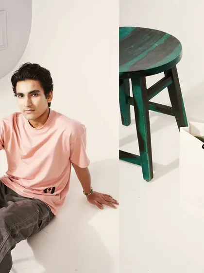 For e-commerce, every detail matters. This split-panel shot features a model wearing a pink crewneck t-shirt for context, alongside a product-focused image of a branded bag and stool. This approach provides both lifestyle feel and clear product information for online stores.
