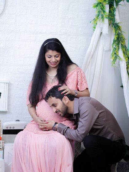 We love capturing these tender interactions. Here, the dad-to-be shares a quiet moment with his baby, set against our cozy teepee backdrop in the studio.