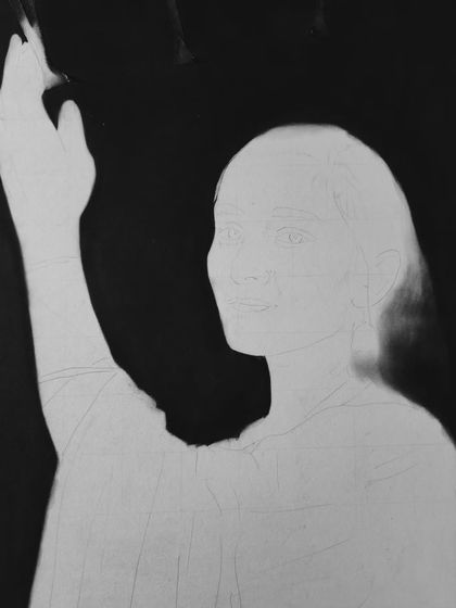 The negative space technique. Here, I've filled the entire background with black charcoal, leaving the outline of the subject to be filled in with graphite.