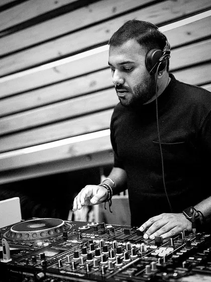 Deep in concentration, lining up the next track. Crafting the perfect set for a club night involves a mix of technical skill and feeling the vibe of the room.