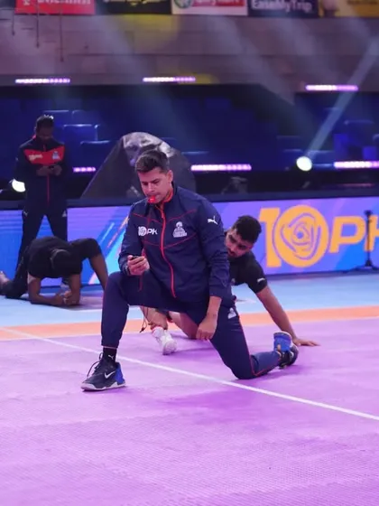 On-mat mobility work is part of our pre-match warm-up. Here, I'm leading the team through dynamic stretches to prepare their hips and shoulders for the game.