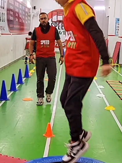 A young athlete shows great focus while jumping on the trampoline. This activity is not just fun; it's a great workout for improving balance and core strength.