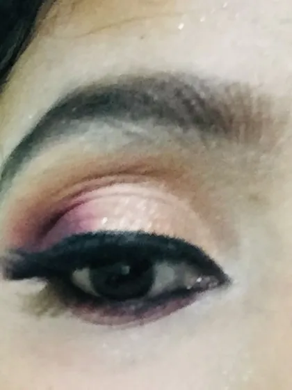A close-up of a classic Indian bridal eye makeup look. I used a blend of warm pinks and shimmering gold eyeshadow to create a defined cut crease, finished with a sharp winged eyeliner. This technique makes the eyes the star of the show and photographs beautifully.