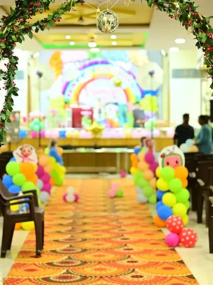 The entrance to the Cocomelon party, featuring a leafy archway and balloon-lined aisle that builds excitement for the main event.