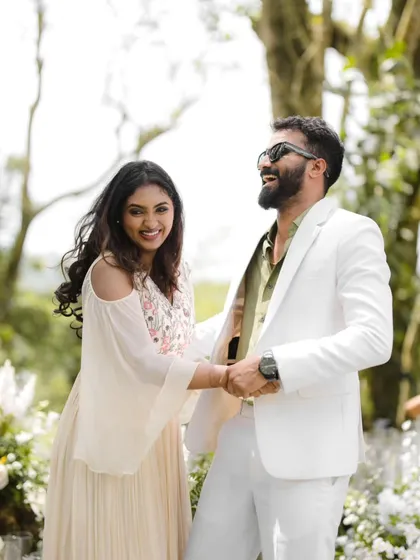 Pure, unscripted laughter. This candid moment between Midhun and Anjana is full of life and happiness, a perfect memory from their beautiful outdoor wedding.