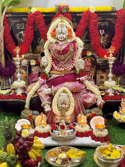 A close-up of the deity, adorned with flower garlands and our beautiful pink silk saree.