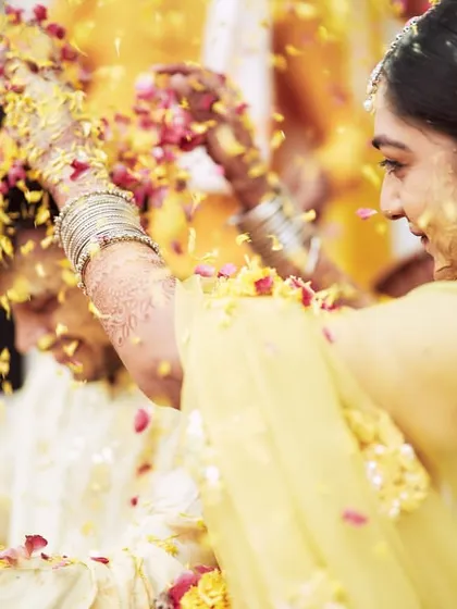 A close-up of the couple during a flower shower at their Haldi, capturing a moment of pure bliss.
