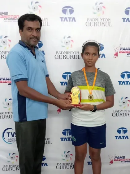 A young champion with her trophy and medal. We ensure every winner feels celebrated.