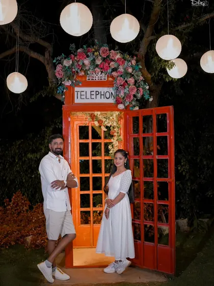 A quirky and fun night shot with a classic red telephone booth prop, decorated with flowers and lights. We have many unique props for your shoot.